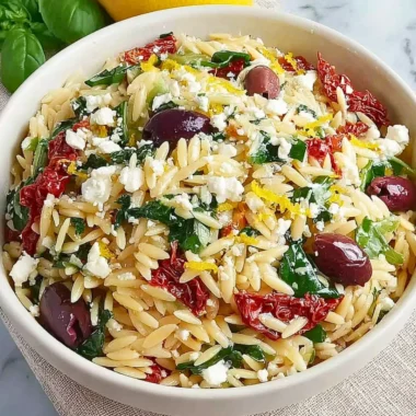 Homemade orzo pasta salad with feta cheese and sun-dried tomatoes