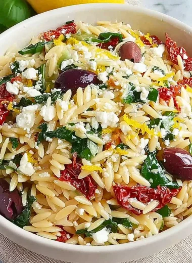 Homemade orzo pasta salad with feta cheese and sun-dried tomatoes