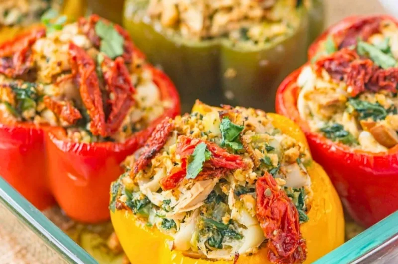 Plate of Mediterranean Chicken stuffed bell peppers, garnished and ready to serve.