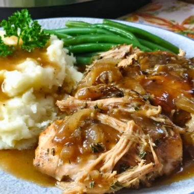 Juicy Mississippi Chicken served with spicy sauce and garnished with herbs