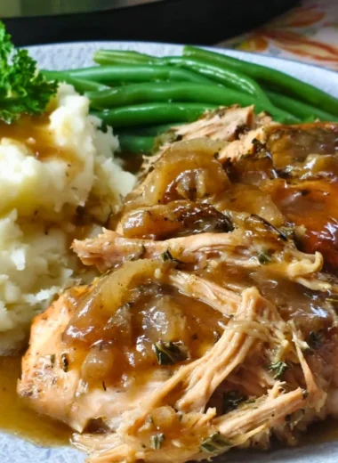Juicy Mississippi Chicken served with spicy sauce and garnished with herbs