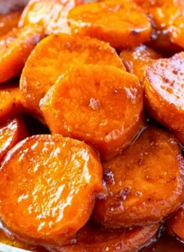 Delicious Southern candied sweet potatoes garnished with spices and syrup