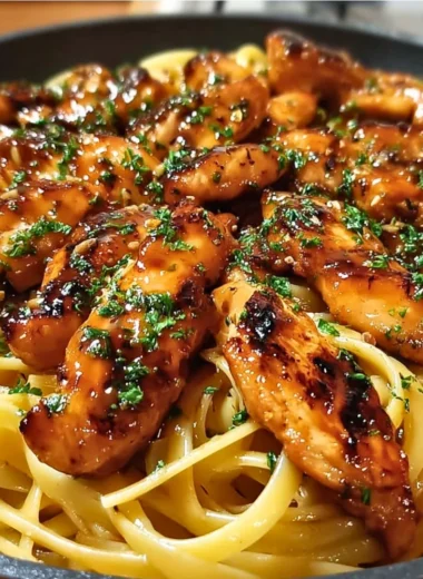 Delicious sticky smoky garlic butter chicken pasta served in a bowl.