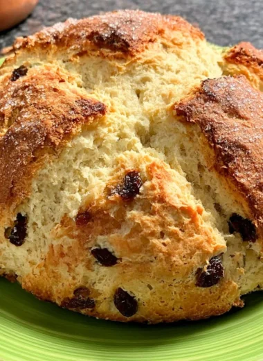 A freshly baked loaf of Amazingly Easy Irish Soda Bread on a wooden table