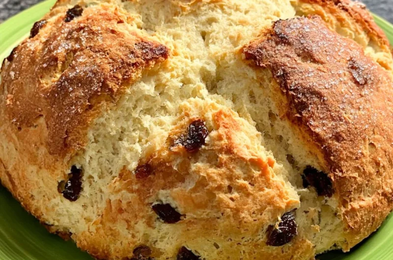 A freshly baked loaf of Amazingly Easy Irish Soda Bread on a wooden table