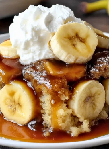 Delicious Bananas Foster Cobbler topped with caramelized bananas and sauce.