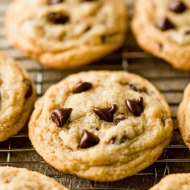 Freshly baked chocolate chip cookies on a cooling rack