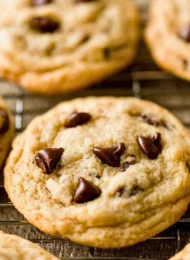Freshly baked chocolate chip cookies on a cooling rack