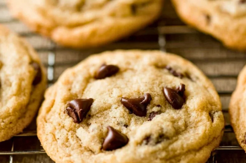 Freshly baked chocolate chip cookies on a cooling rack