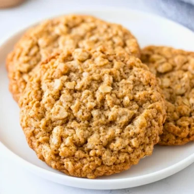 Freshly baked chewy oatmeal cookies on a cooling rack
