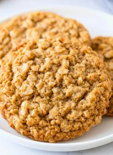 Freshly baked chewy oatmeal cookies on a cooling rack