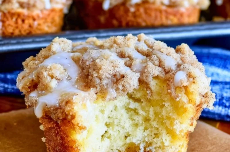 Freshly baked coffee cake muffins topped with a crumbly streusel