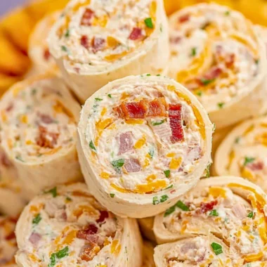 Plate of delicious Crack Chicken Pinwheels garnished with herbs.