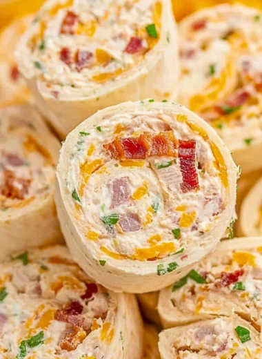 Plate of delicious Crack Chicken Pinwheels garnished with herbs.