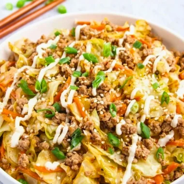 Delicious egg roll in a bowl served in a colorful dish with fresh vegetables.