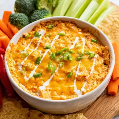 Bowl of Healthy Buffalo Chicken Dip garnished with green onions