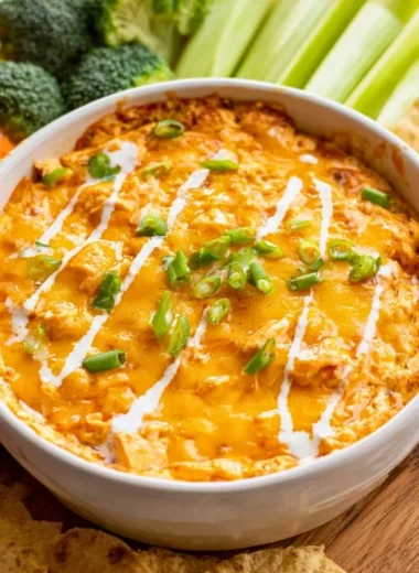 Bowl of Healthy Buffalo Chicken Dip garnished with green onions