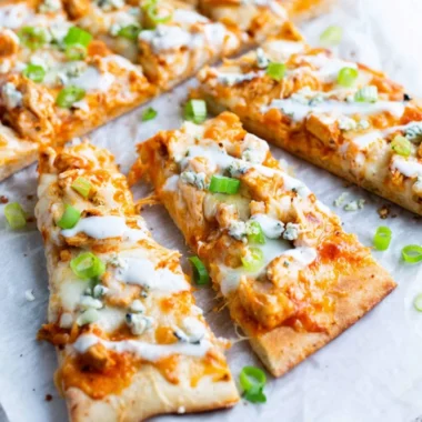High Protein Buffalo Chicken Flatbread topped with fresh greens and sauce