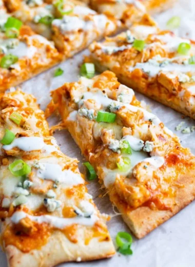 High Protein Buffalo Chicken Flatbread topped with fresh greens and sauce