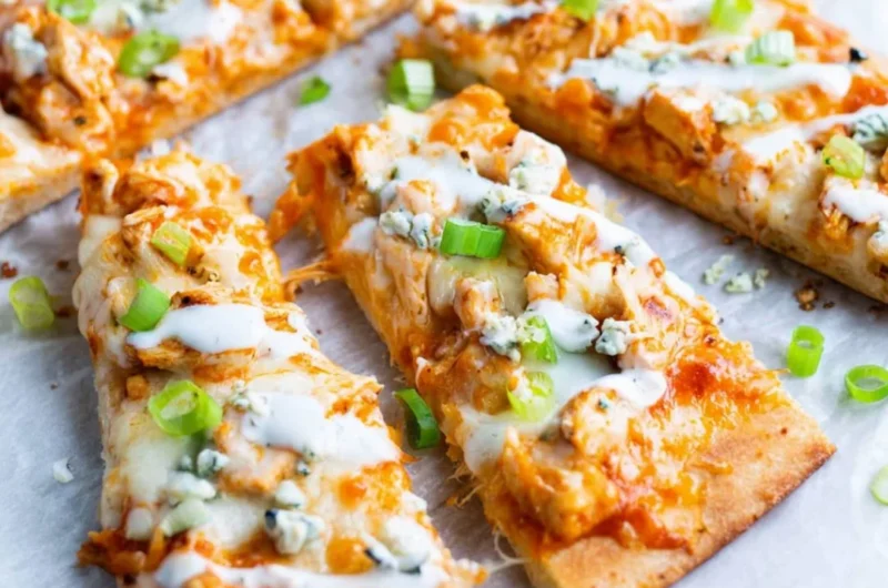 High Protein Buffalo Chicken Flatbread topped with fresh greens and sauce