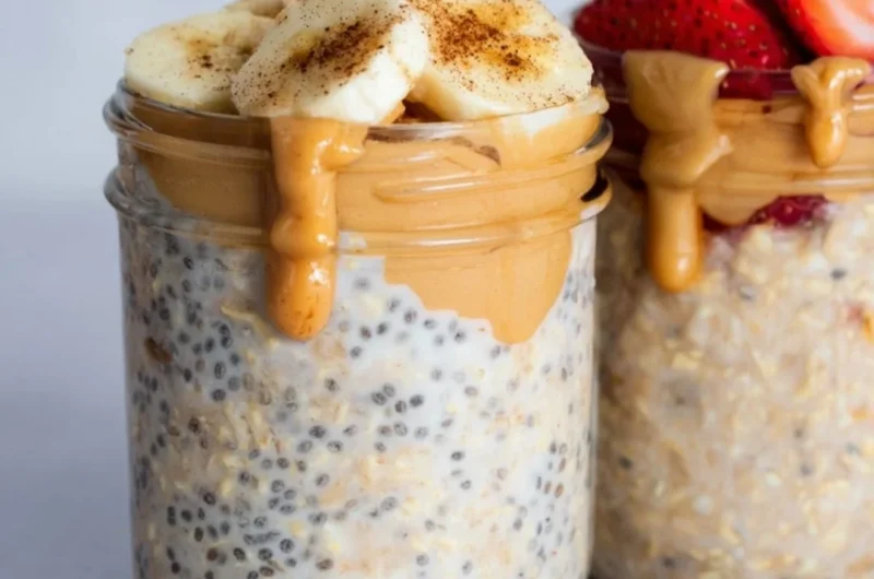 Bowl of high-protein overnight oats topped with fruits and nuts.