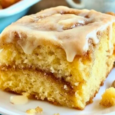 Delicious homemade cinnamon roll cake topped with creamy glaze and cinnamon