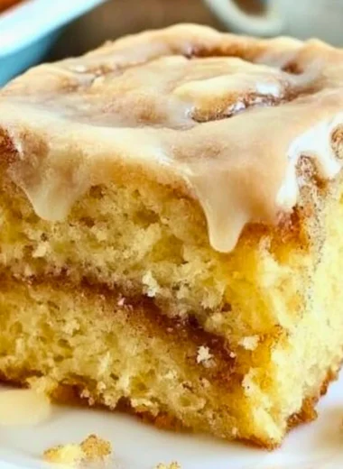 Delicious homemade cinnamon roll cake topped with creamy glaze and cinnamon