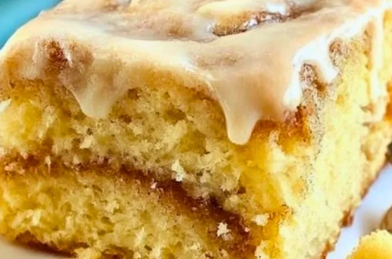 Delicious homemade cinnamon roll cake topped with creamy glaze and cinnamon