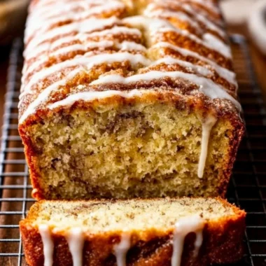 Loaf of homemade cinnamon swirl banana bread with a golden crust and rich texture