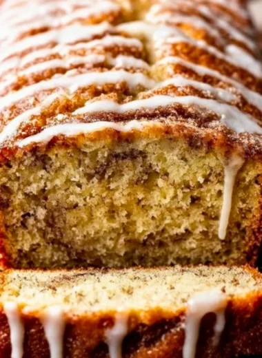 Loaf of homemade cinnamon swirl banana bread with a golden crust and rich texture