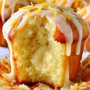Freshly baked Lemon Cream Cheese Muffins on a rustic table