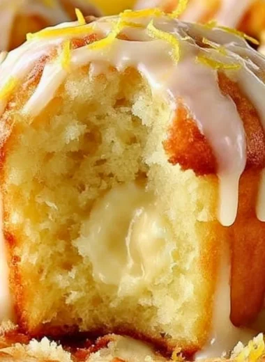 Freshly baked Lemon Cream Cheese Muffins on a rustic table