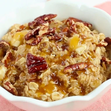 Delicious Maple Pecan Baked Oatmeal served in a bowl with pecans and maple syrup
