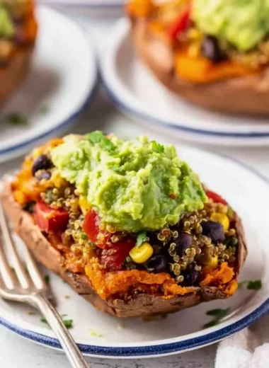 Mexican quinoa stuffed sweet potatoes topped with fresh herbs and spices