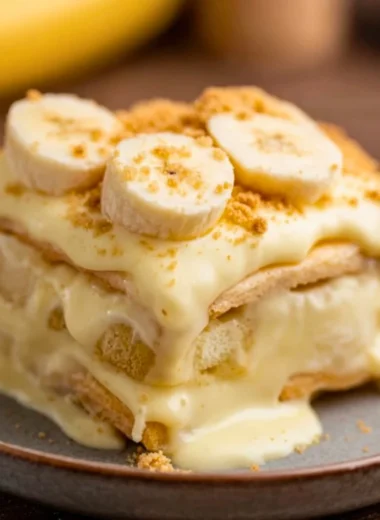 Bowl of old-fashioned homemade banana pudding with fresh bananas and whipped cream