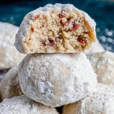 Delicious Pecan Snowball Cookies dusted with powdered sugar on a plate