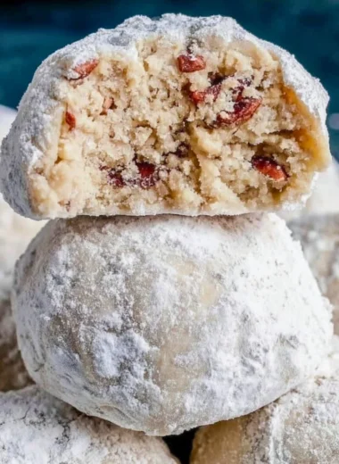 Delicious Pecan Snowball Cookies dusted with powdered sugar on a plate