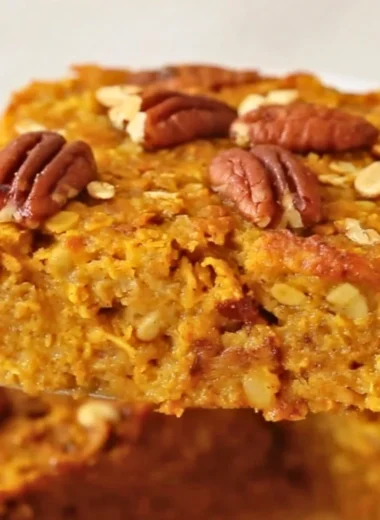 Delicious pumpkin baked oatmeal topped with nuts and spices, ready to serve.