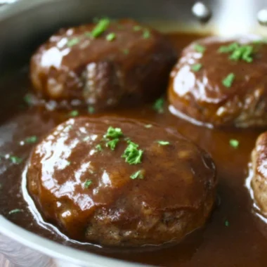 Plate of homemade simple Salisbury steak with gravy and sides