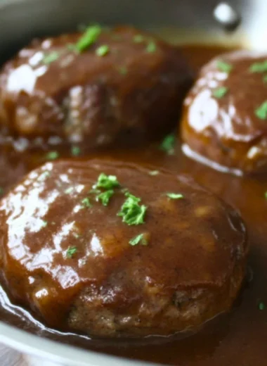Plate of homemade simple Salisbury steak with gravy and sides
