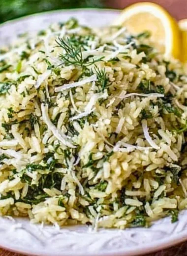 Bowl of spinach rice with fresh spinach and rice grains