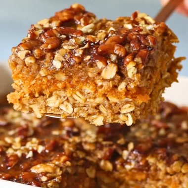 Delicious Sweet Potato Baked Oatmeal in a serving dish topped with nuts and fruits