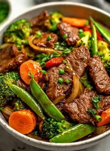 Beef stir fry with colorful vegetables in a skillet