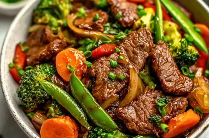 Beef stir fry with colorful vegetables in a skillet