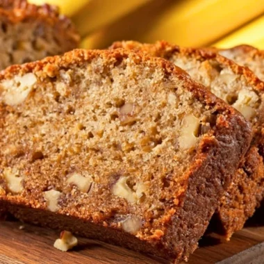 Delicious slice of moist banana bread on a wooden table