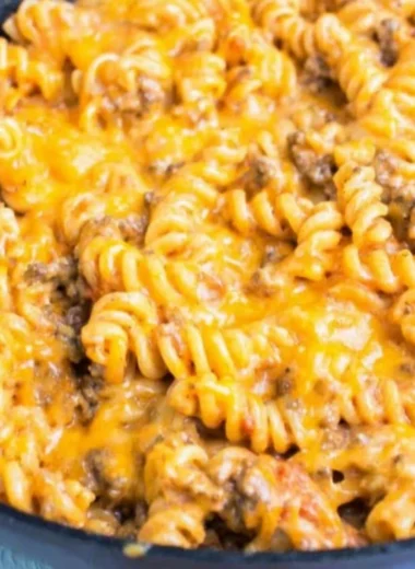 Cheesy taco pasta topped with melted cheese and fresh ingredients