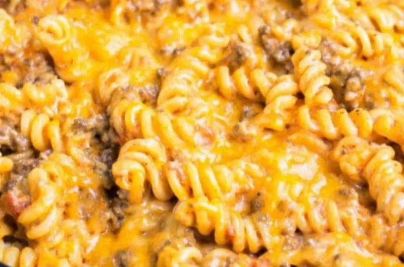 Cheesy taco pasta topped with melted cheese and fresh ingredients