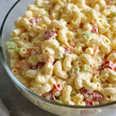 Bowl of classic creamy macaroni salad with vegetables and dressing