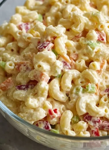 Bowl of classic creamy macaroni salad with vegetables and dressing