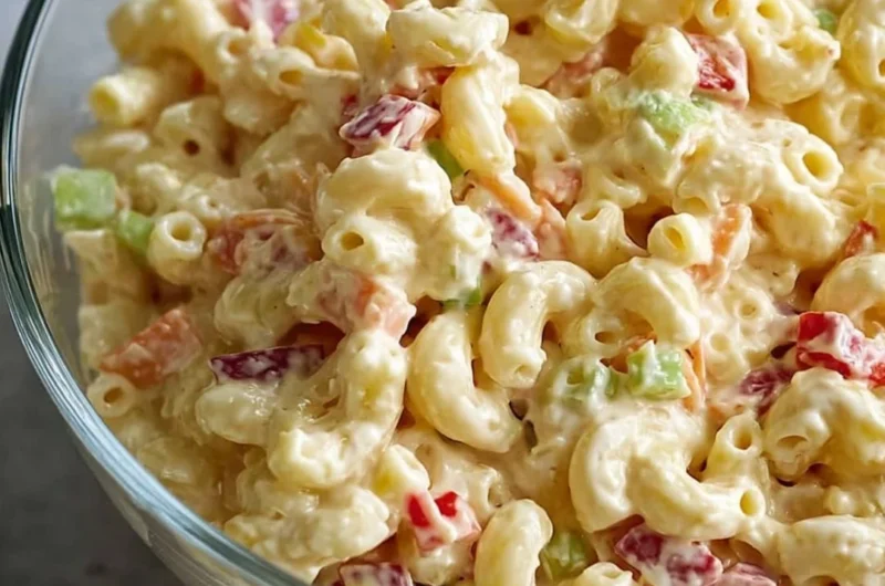 Bowl of classic creamy macaroni salad with vegetables and dressing